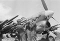 Ground_crews_loading_3-inch_rocket_projectiles_onto_a_Hawker_Typhoon_Mk_IB_of_No._247_Squadron_RAF_at_B2-Bazenville,_Normandy,_1